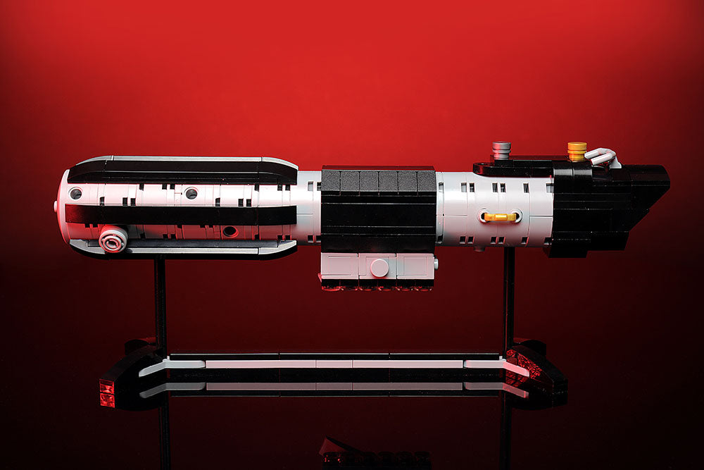 Life Size Darth Vader's Saber Hilt w/ Stand by B3 Customs displayed against a red background, showcasing detailed LEGO brick construction and sleek black and silver design.