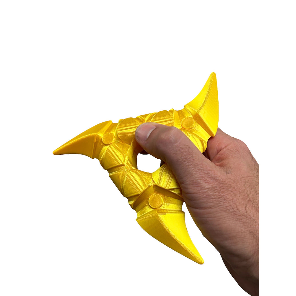 Hand holding a bright yellow 3D printed Life-Size Shuriken Throwing Star / Cosplay by B3 Customs with a detailed, stylized ninja star design.