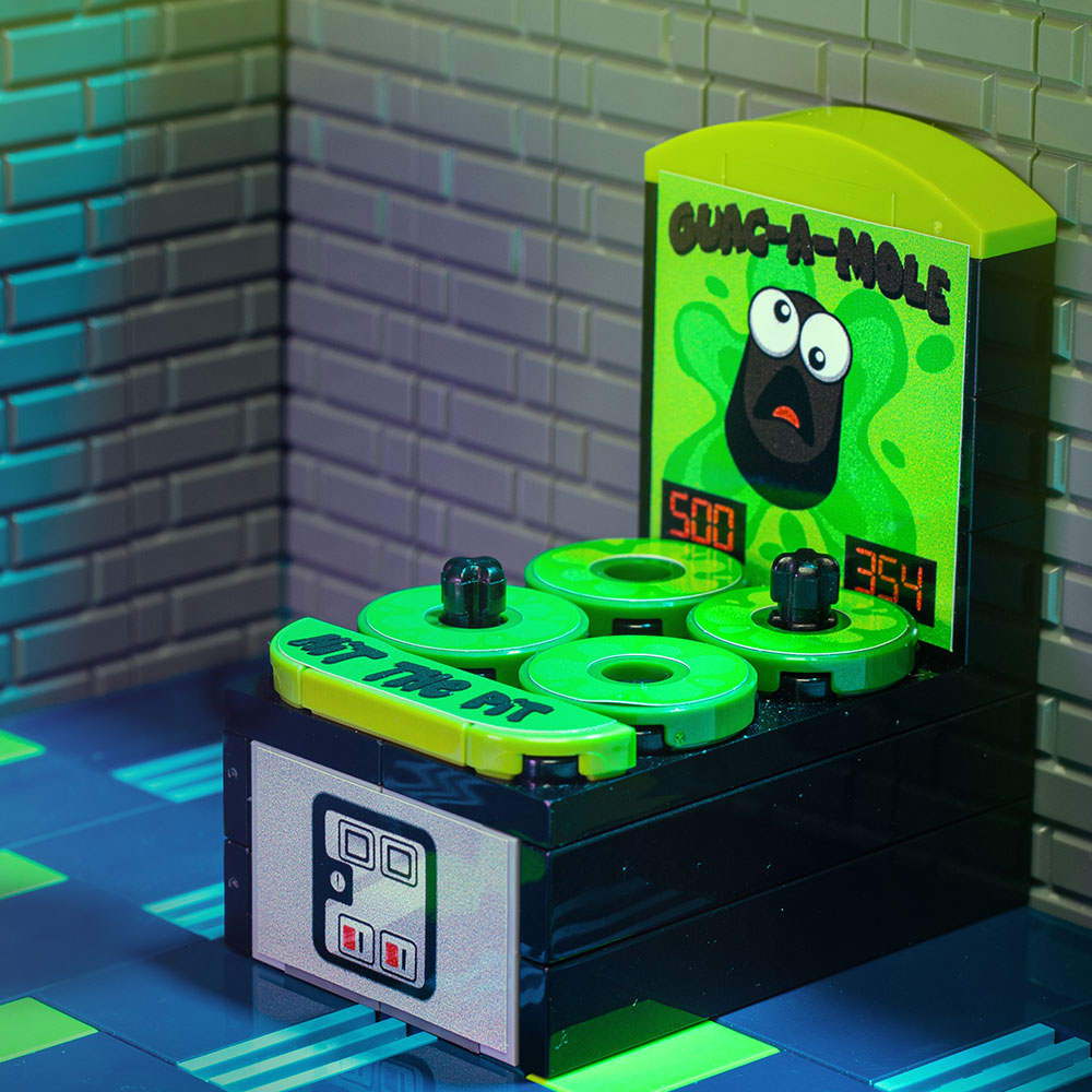 A detailed LEGO arcade game model featuring "Guac-A-Mole - Custom Arcade Whac-A-Mole Set made using LEGO parts - B3 Customs" with bright green whack-a-mole holes and a cartoon moles theme.