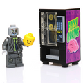 A custom LEGO Fresh Brains Zombie Vending Machine w/ Zombie Minifig by B3 Customs, featuring a detailed zombie minifigure holding a yellow LEGO head next to a purple vending machine branded with "Fresh Brains.