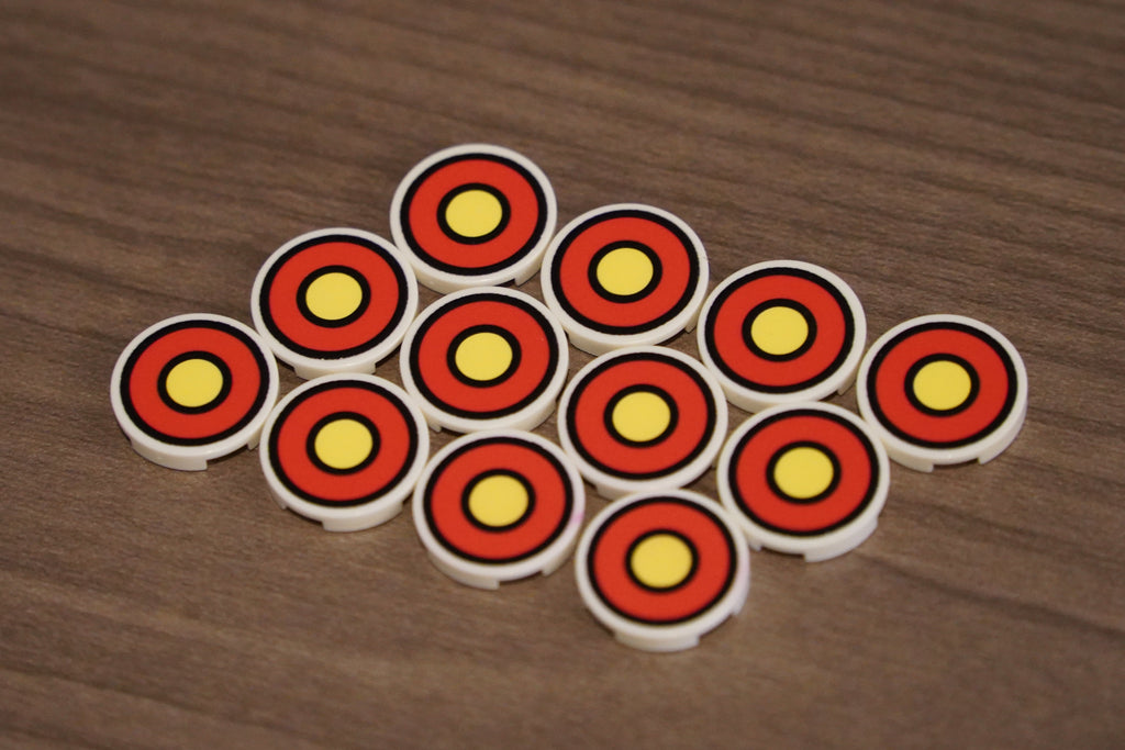 Set of circular objects with red and yellow patterns on a wooden surface