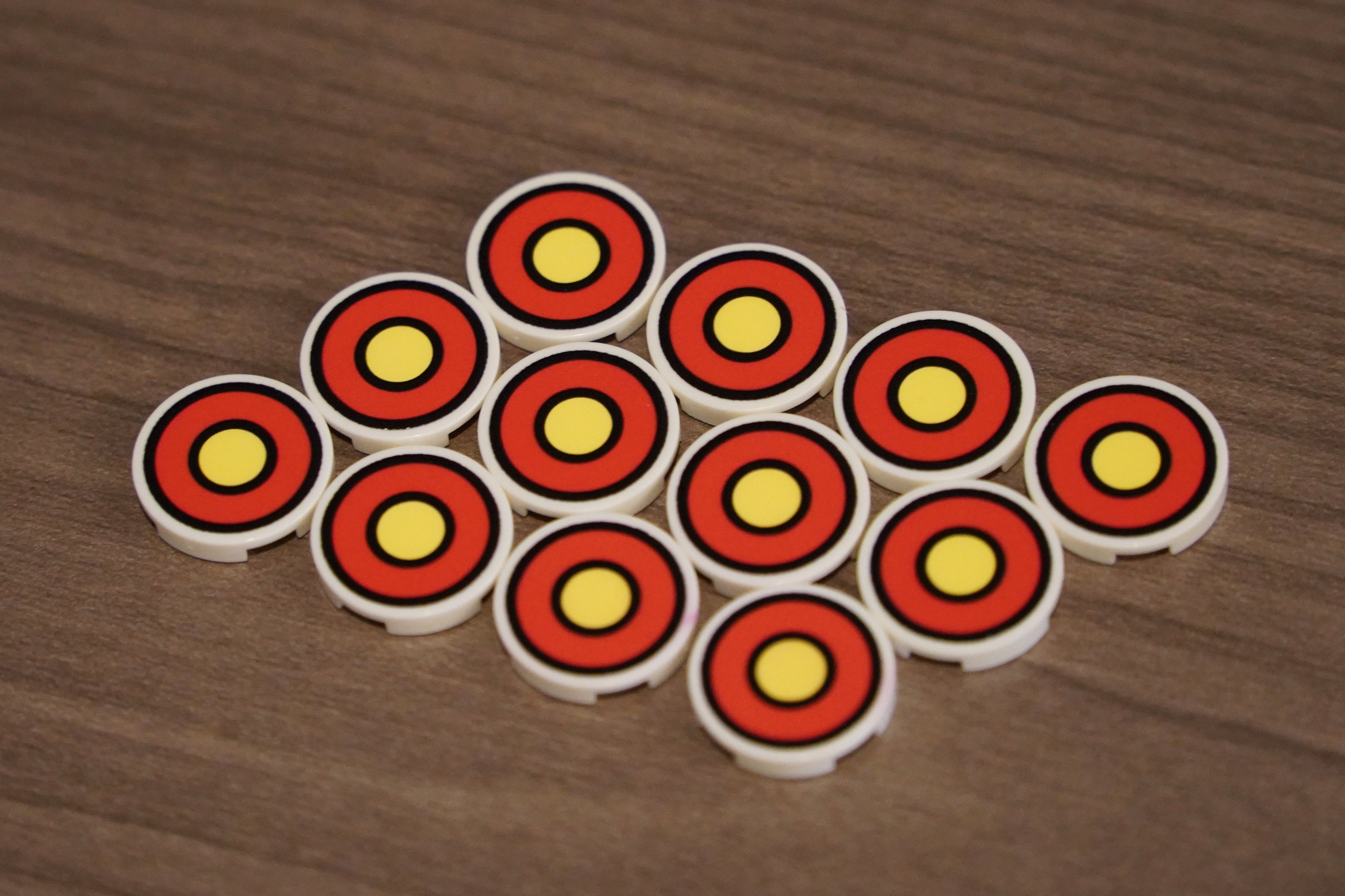 Set of circular objects with red and yellow patterns on a wooden surface