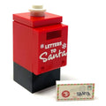 Red and black LEGO mailbox with "Letters to Santa" text and white snowflake decals, accompanied by a small LEGO envelope with a festive stamp, part of the Letter to Santa Mailbox and Envelope made using LEGO parts - B3 Customs.
