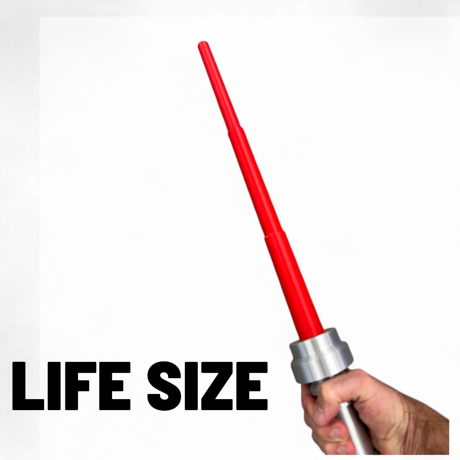 Hand holding a life-size saber hilt with retractable red blade / cosplay made by B3 Customs, featuring a metallic handle and a bright red extendable blade.