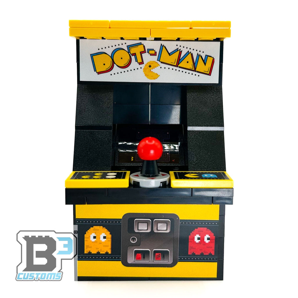 Front view of the GIANT! Dot-Man Arcade Machine made using LEGO parts - B3 Customs, featuring a red joystick and classic pixel ghost designs on a yellow and black build by B3 Customs.
