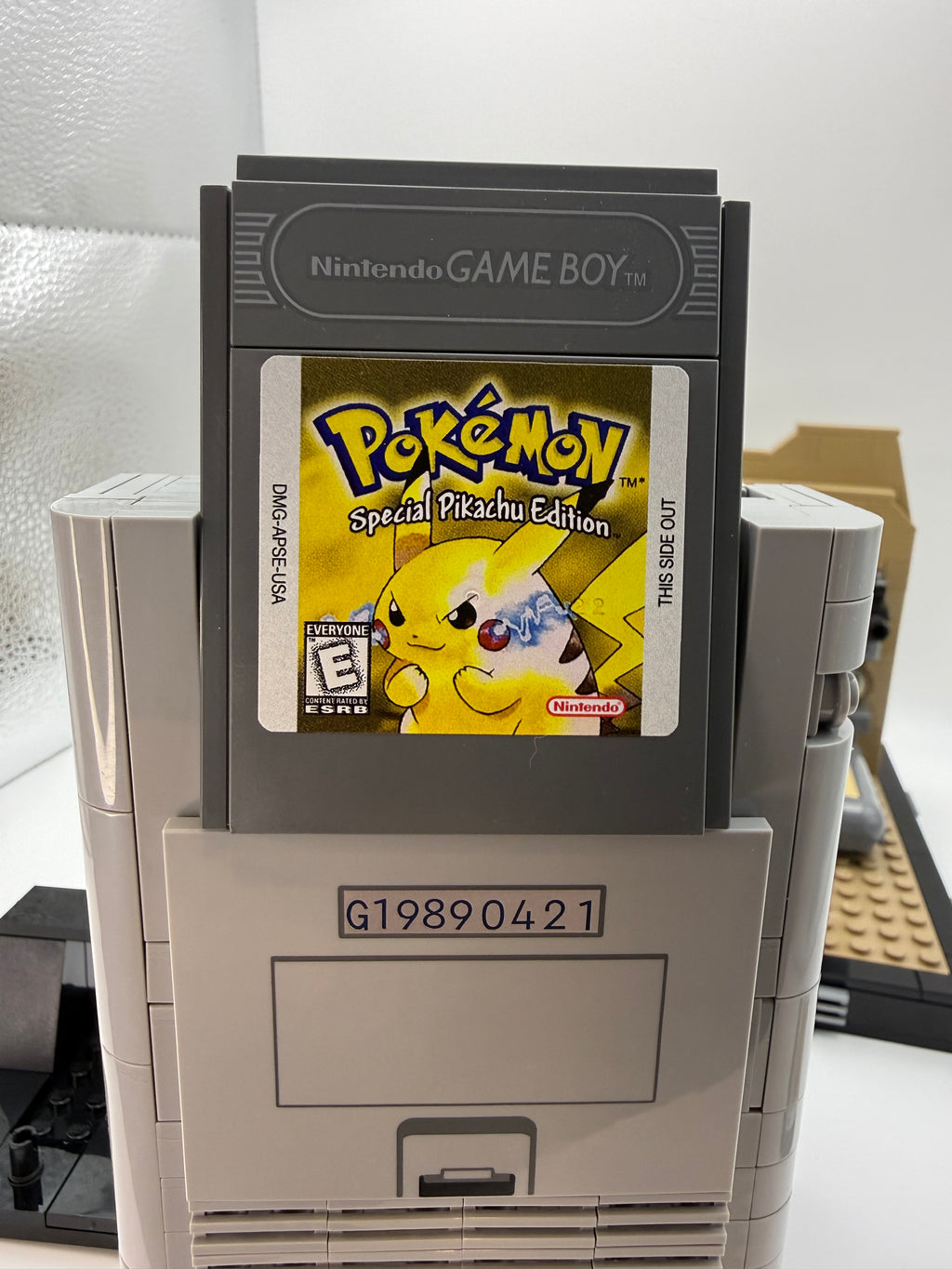 A close-up of a Nintendo Game Boy cartridge featuring a custom printed tile label of Pokémon Special Pikachu Edition, part of the Printed Tile Upgrade Kit for GB Set Game Cartridge.
