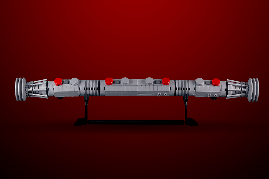 Maul Saber w/ Stand - Custom MOC made with LEGO bricks by B3 Customs, showcasing a detailed life-size LEGO brick lightsaber on a black display stand against a red background.