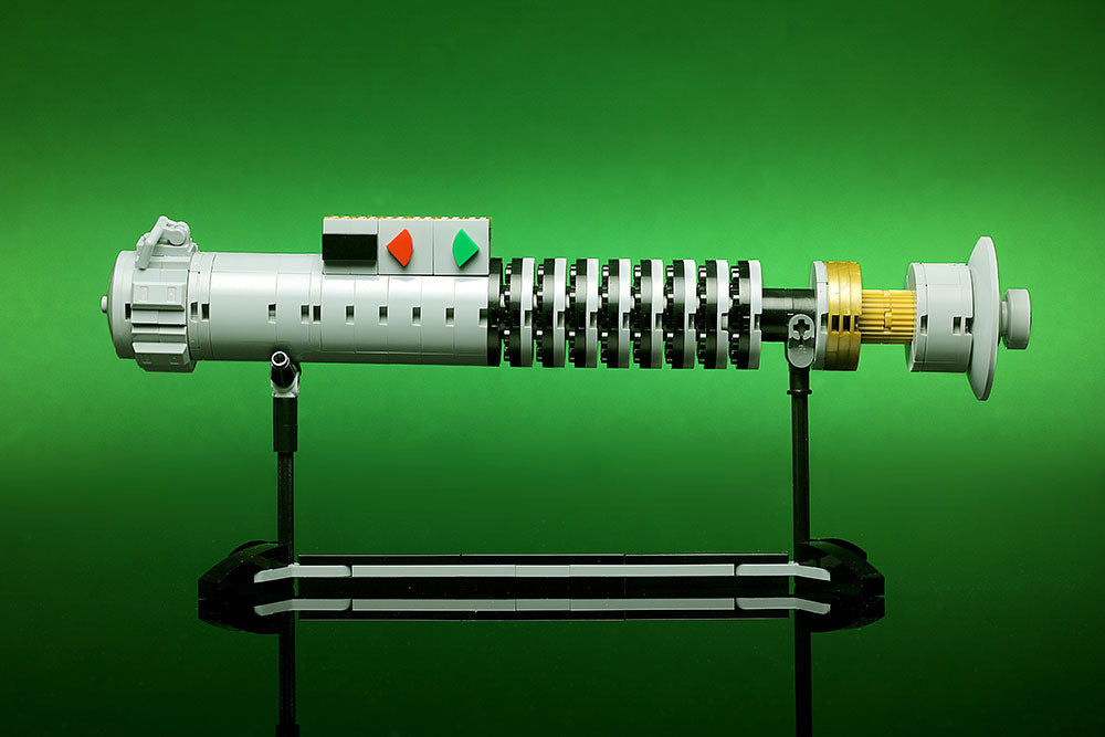 Luke Skywalker ROTJ Lightsaber w/ Stand - Custom MOC made with LEGO bricks by B3 Customs, featuring detailed black, white, and gold brick construction on a display stand.