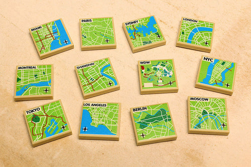 Set of miniature wooden map tiles each representing a different major city or location, featuring detailed streets and landmarks as part of the B3 Customs® International Maps Pack.