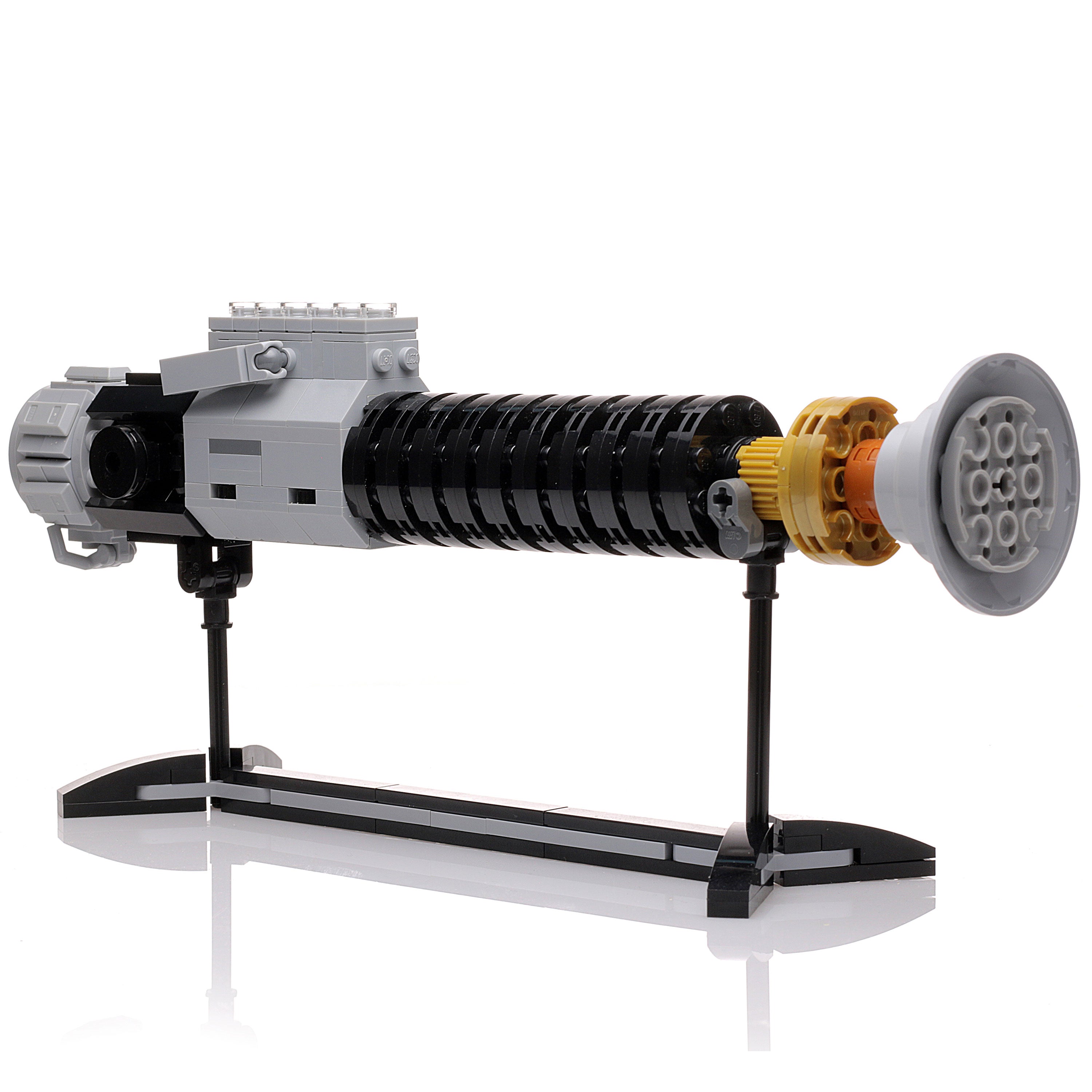 Obi-Wan Lightsaber w/ Stand made with LEGO parts displayed horizontally on a sleek black stand, featuring detailed black, gray, and gold elements in a custom brick MOC design.