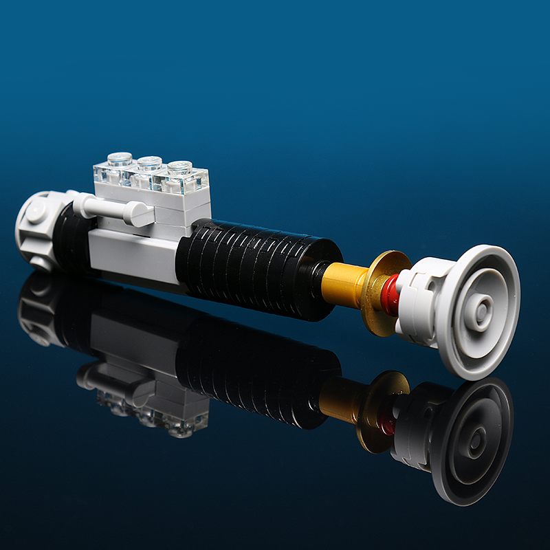 Old Ben Mini Lightsaber Building Kit made using LEGO parts - B3 Customs, featuring detailed black, white, and gold LEGO components assembled to resemble a miniature lightsaber.