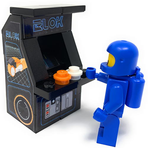 Blue LEGO minifigure playing a BLOK Legacy Classic Arcade Machine with detailed decals by B3 Customs, capturing an authentic retro arcade gaming experience.