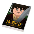 Hobbrick Movie Cover (2x3 Tile) made using LEGO parts - B3 Customs features a custom LEGO tile depicting a stylized hobbit character holding a sword with the title "The Hobrik: An Unassembled Journey" in bold letters.