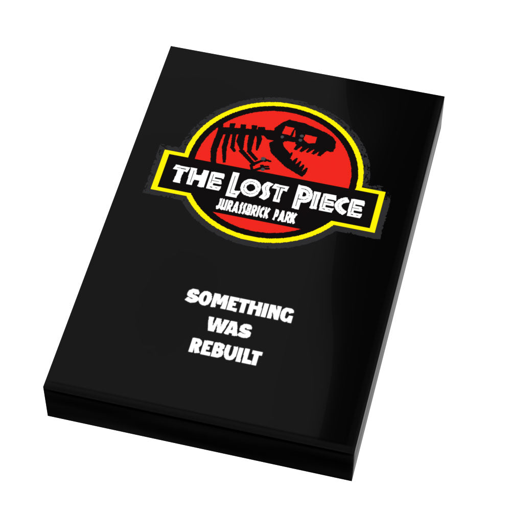 Box featuring a custom printed tile with a parody logo of a dinosaur skeleton in red and yellow, titled "Jurassbrick Park 2: The Lost Piece Movie Cover (2x3 Tile) - B3 Customs," with the phrase "Something Was Rebuilt.