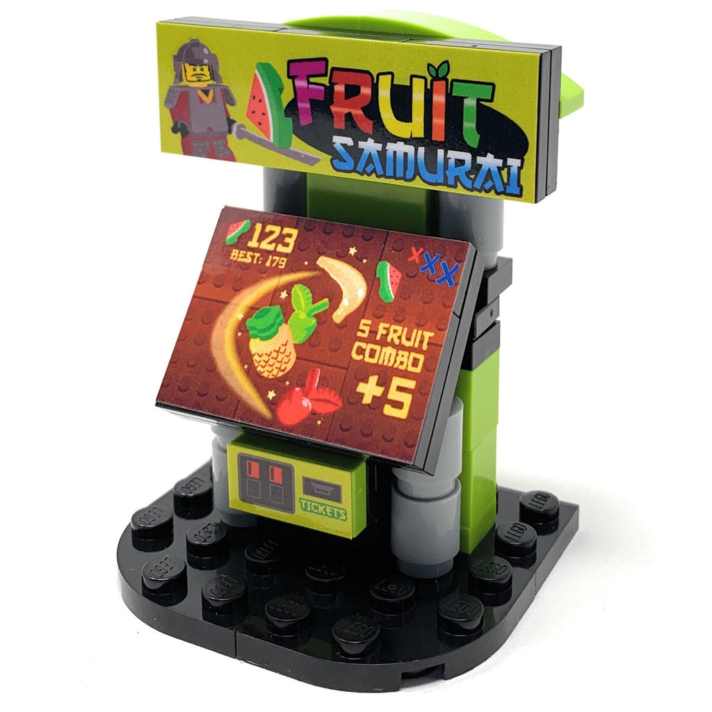 Miniature arcade machine model featuring colorful fruit-themed gameplay graphics, crafted from LEGO bricks by B3 Customs, titled Fruit Samurai Arcade Building Set made using LEGO parts - B3 Customs.