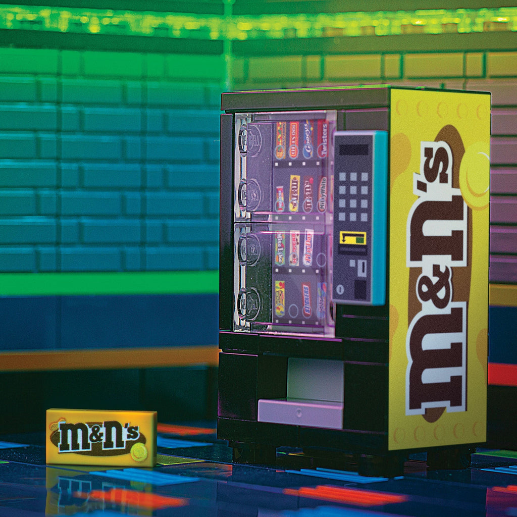 M&Ns (Peanut) Candy Vending Machine made using LEGO parts - B3 Customs, a detailed miniature LEGO vending machine featuring custom printed tiles and vibrant M&Ms branding by B3 Customs.